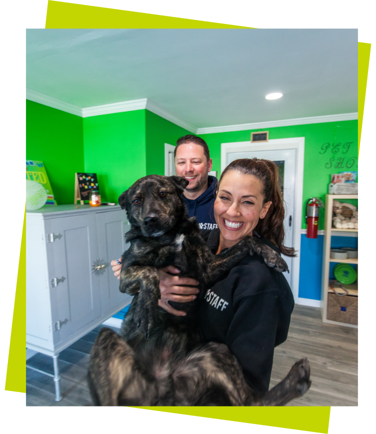 Health Benefits a woman holding a black dog with a man in the background and green border